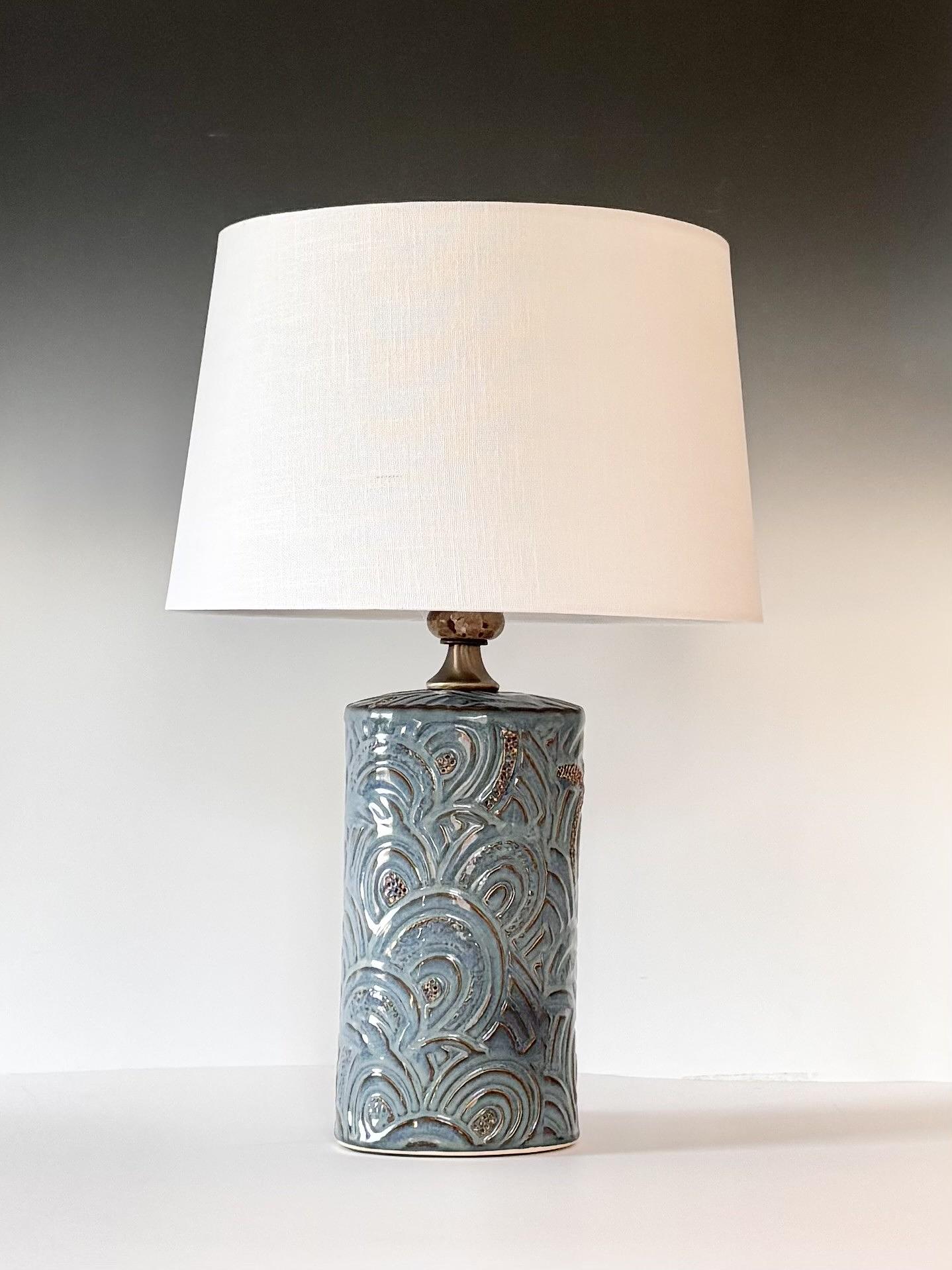 A repurposed muddled brown stone makes the neck of this lamp highlight the base & color